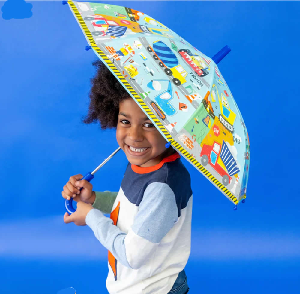 Child using a construction design umbrella