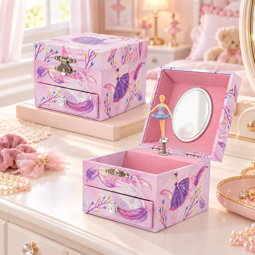 A pink fairy-themed jewelry box set displayed on a vanity table. One box is closed, showing a purple fairy illustration, floral pattern, and silver clasp.