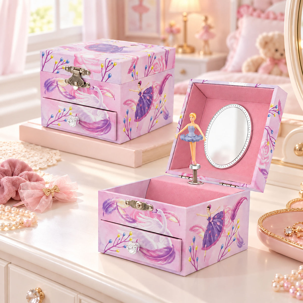 A pink fairy-themed jewelry box set displayed on a vanity table. One box is closed, showing a purple fairy illustration, floral pattern, and silver clasp.